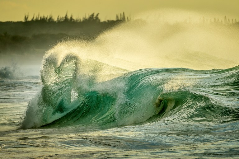Hearth shaped wave, Papohaku beach, Molokai Hawaii. Storms in the Bering sea pump winter swells onto the shores of Molokai.